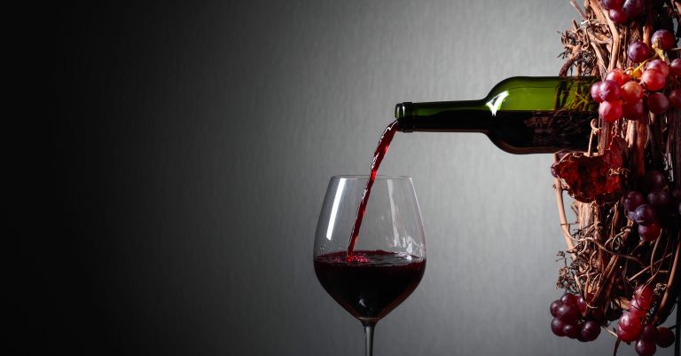 Red wine pouring from a bottle into a glass