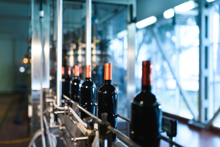 line with bottles at wine factory